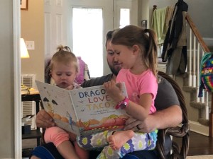 uncle reading with nieces