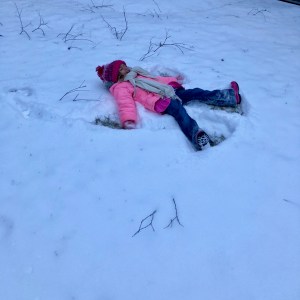 girl making a snow angel