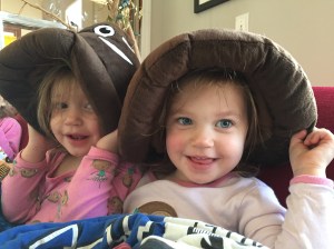 girls with poop emoji hats