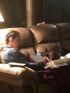 woman on coach with chocolate lab