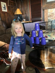 girl playing with cups